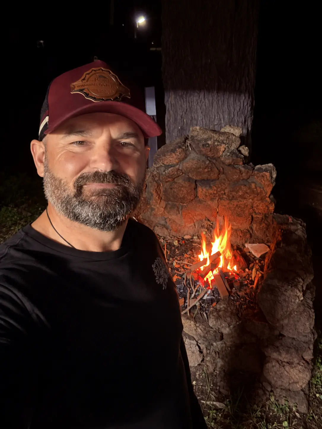 Tony Smith beside a fire